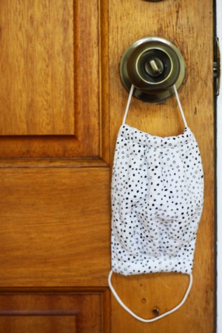 Facemask hanging on a door knob